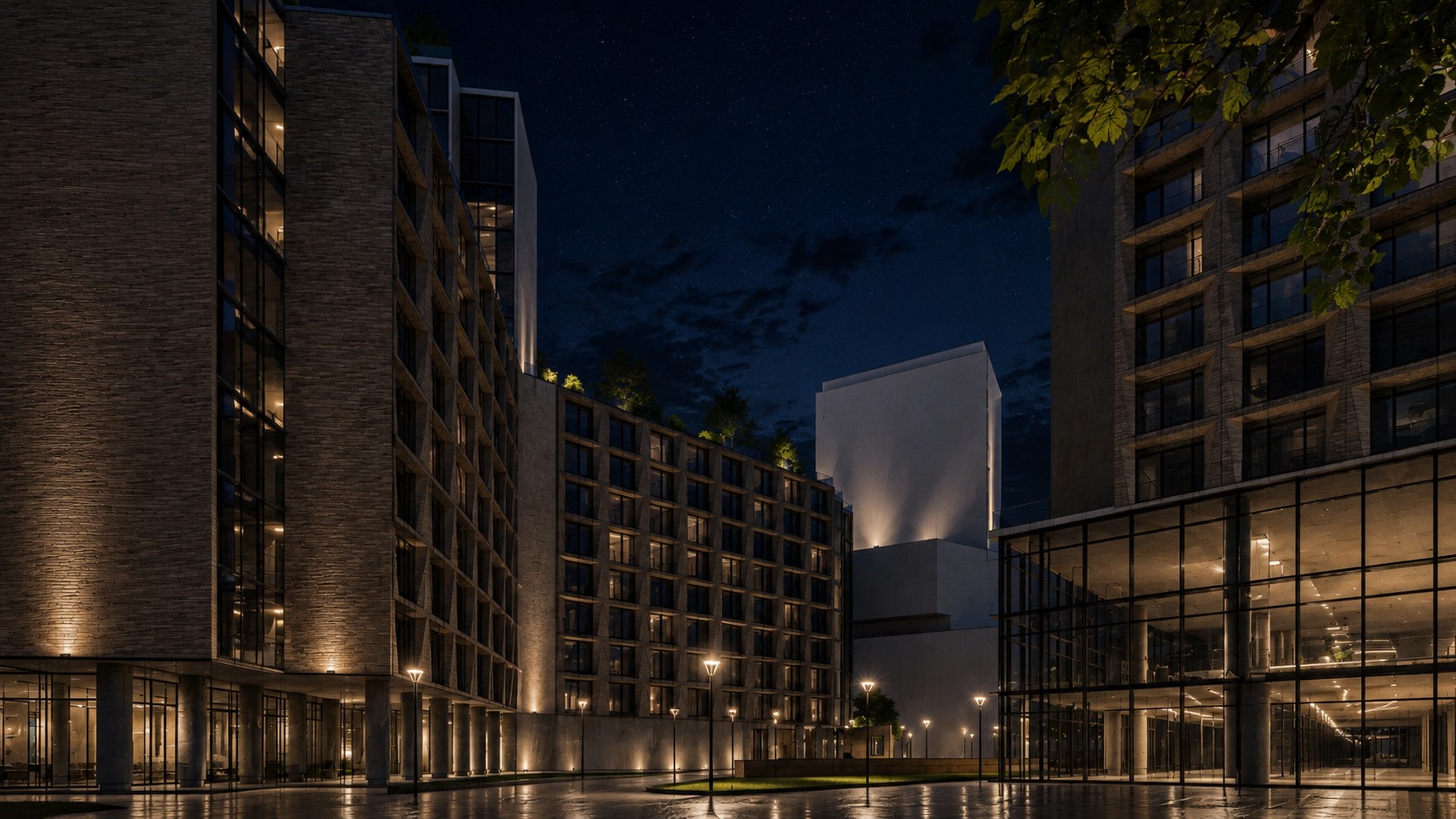 Night — ground-floor retail and lobby glazing beneath the blocks