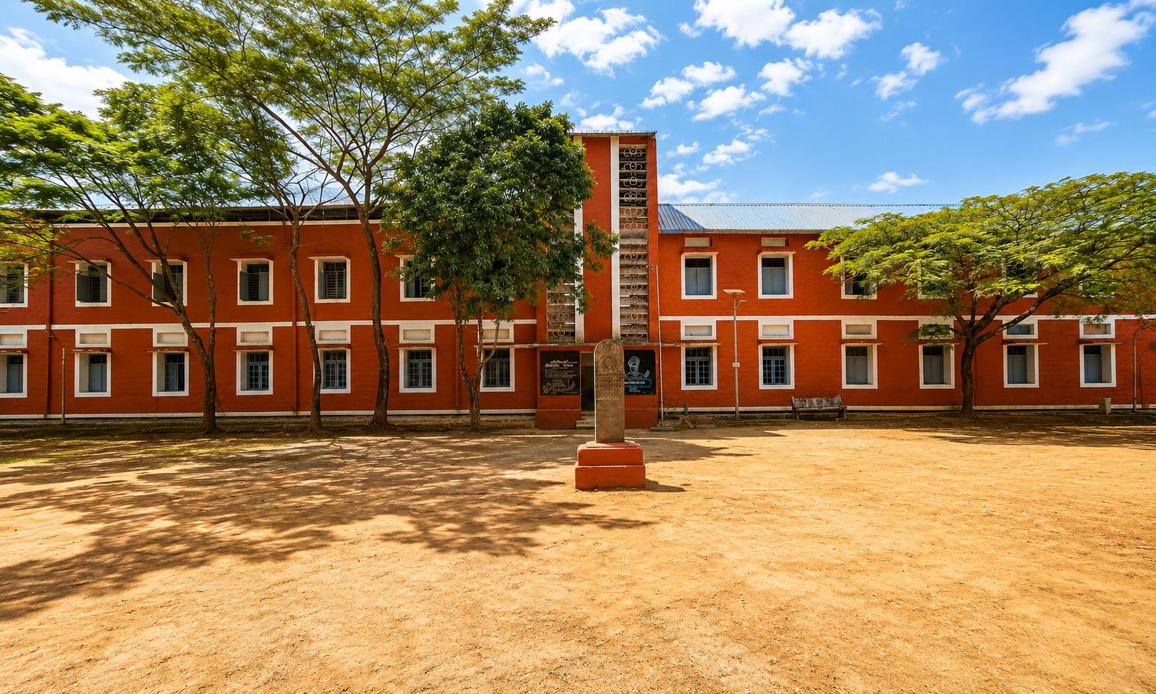 Classroom block — repainted facade with a memorial plaque