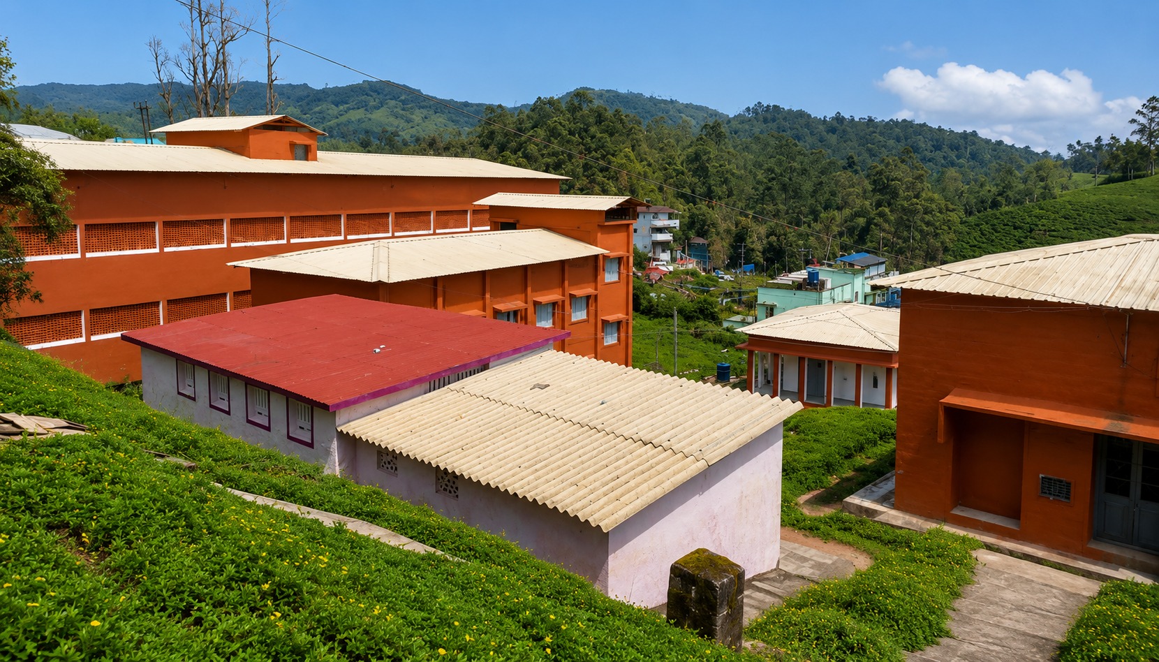 Roofscape — new corrugated roofing across the campus, hills beyond