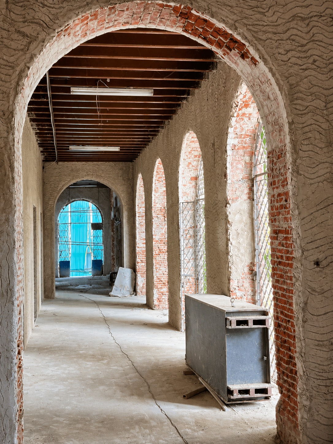 Colonnade — arched corridor, brick arches mid-repair