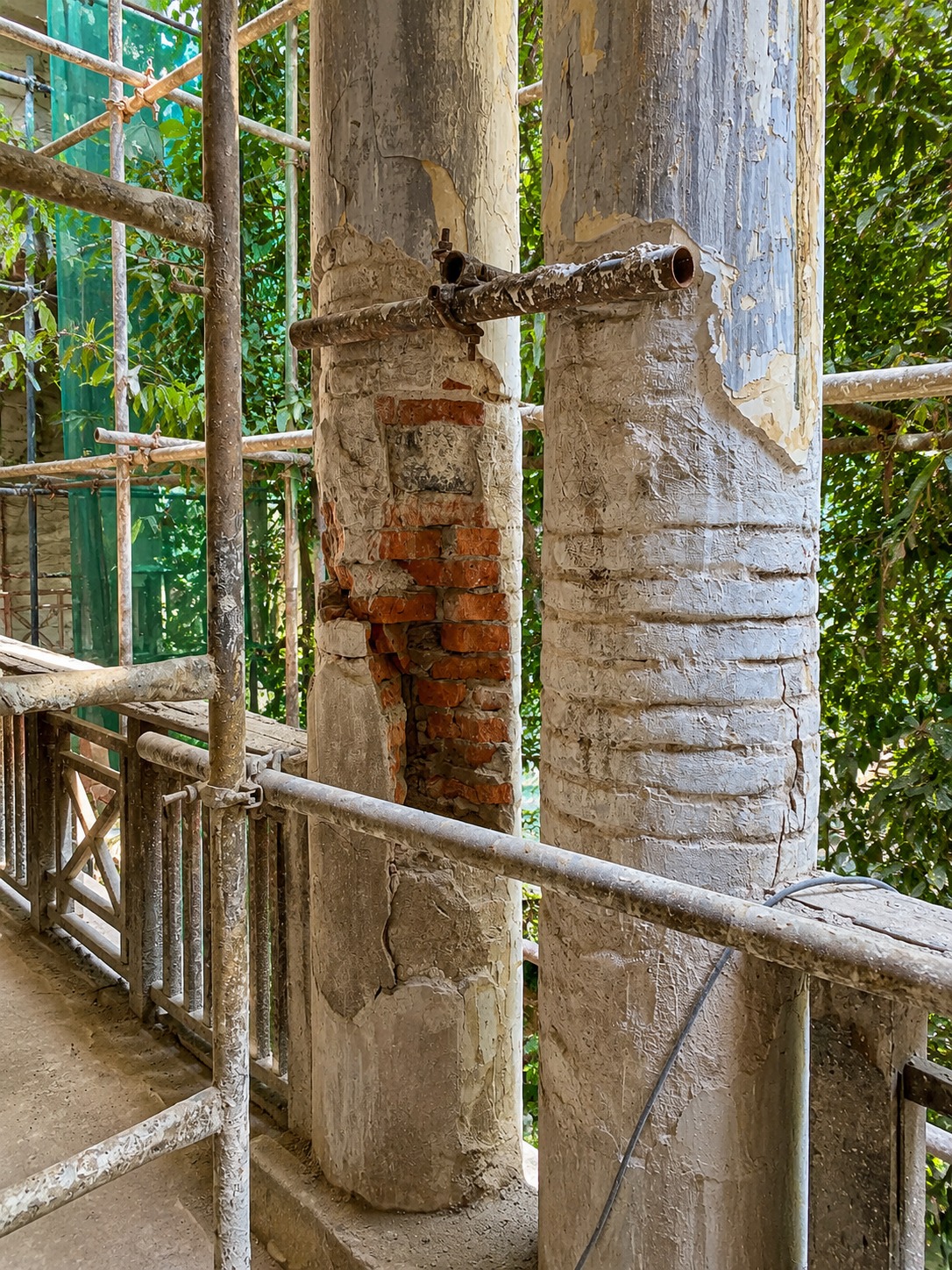 Column — lime plaster repair exposing the original brick core
